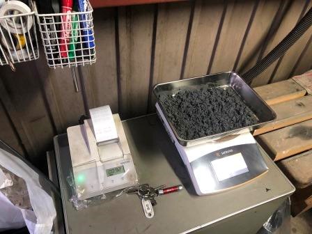 Weighing dried moisture test sample